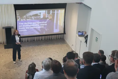 Maaike Andries presenting beside the slide 'The airline-perspective on multimodality starts from the passengers' needs'