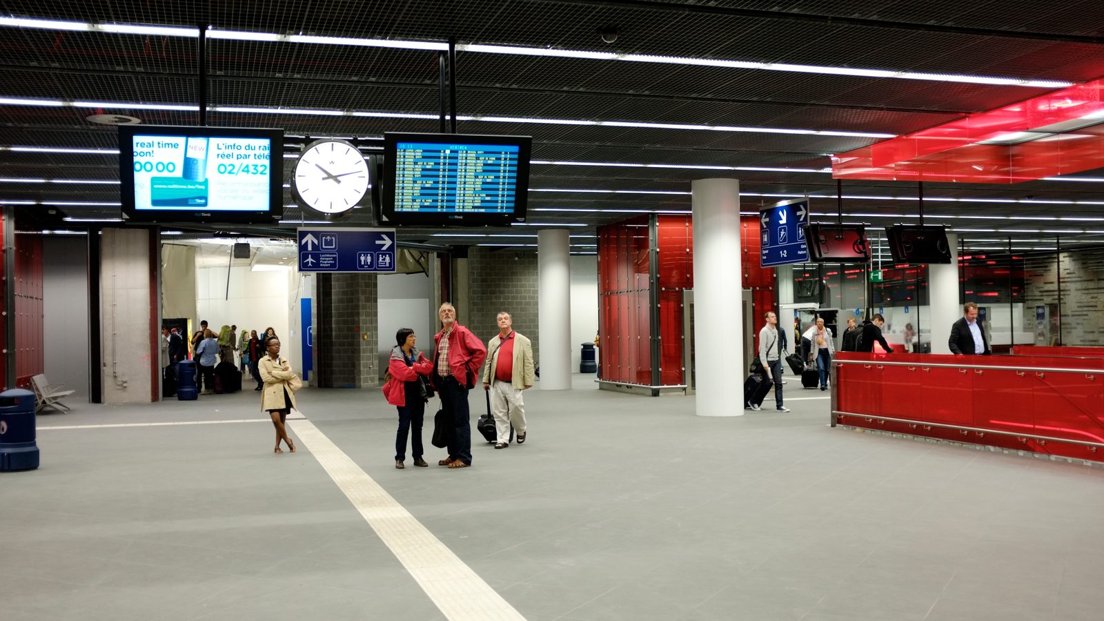 Passengers on the concourse of Brussels Airport-Zaventem station, below the departure boards