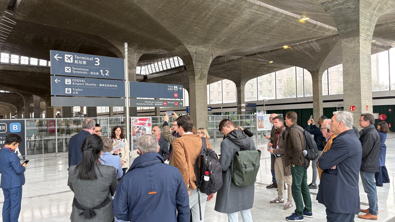 IARO members on a site visit in the Terminal 3 hall at Paris-Charles de Gaulle, under signs for CDGVAL and trains